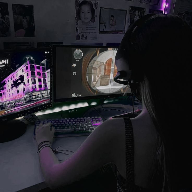 a woman sitting at a desk in front of a computer monitor with headphones on