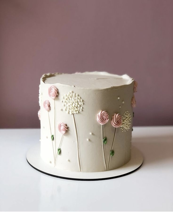 a white cake with pink flowers on it