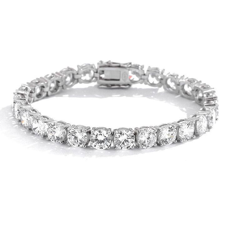 This stunning moissanite gem tennis bracelet is a true showstopper! The bracelet is crafted from high-quality sterling silver, and each of the gems is placed carefully in an elegant setting. The beautiful clear gems are faceted to sparkle beautifully in the light and are the focal point of this piece. Description Round Stone Moissanite Main Stone Clear Color Stone Tennis Bracelet Sterling Silver Fits All Occasions GRA Certified Elegant Round Iced Out Diamond Bracelet, Elegant Iced Out Round Diamond Bracelet, Diamond White Sterling Silver Bracelet With Cubic Zirconia, Elegant Iced Out Round Bracelets, Elegant Iced Out Bracelets, Iced Out Elegant Bracelets, Classic Diamond Bracelet With Prong Setting In Crystal, Classic Crystal Tennis Bracelet With Brilliant Cut, Dazzling Silver Moissanite Bracelets