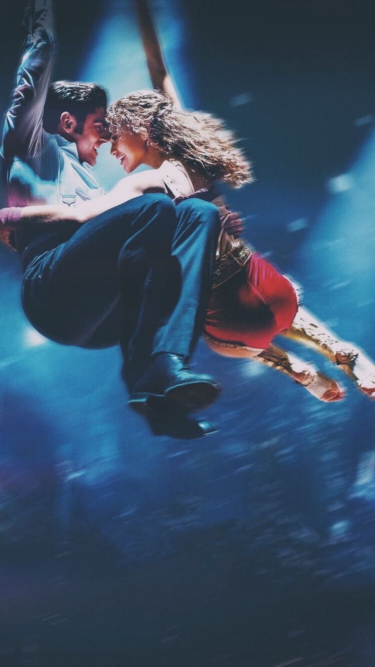 a man and woman are flying through the air