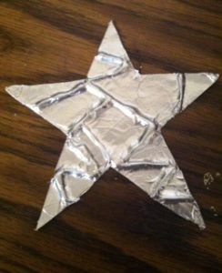 an origami star made out of aluminum foil