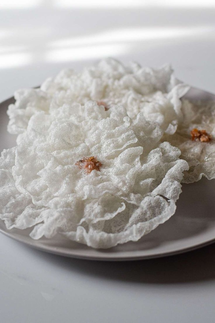 a white plate topped with rice on top of a table