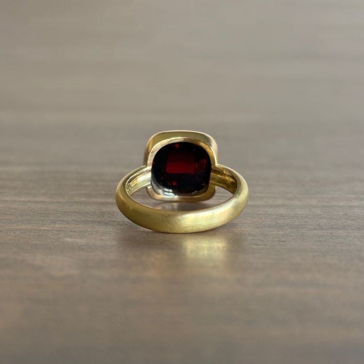 Rich wine hues flash from the depths of this regal, high-profile garnet ring. 18k yellow gold Garnet 10mm x 10mm (3/8" x 3/8") The top of the stone sits 3/8" off the finger Formal Garnet Ring With Polished Finish, Luxury Yellow Gold Rings With Garnet, Yellow Gold Garnet Ring With Polished Finish, Formal Yellow Gold Garnet Birthstone Ring, Yellow Gold Garnet Signet Ring With Gemstone, Timeless Gold Ruby Ring With Bezel Setting, Gold Ruby Ring With Bezel Setting, Formal Gold Rings With Garnet, Formal Gold Garnet Rings