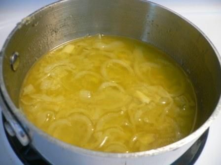 a pot filled with soup sitting on top of a stove