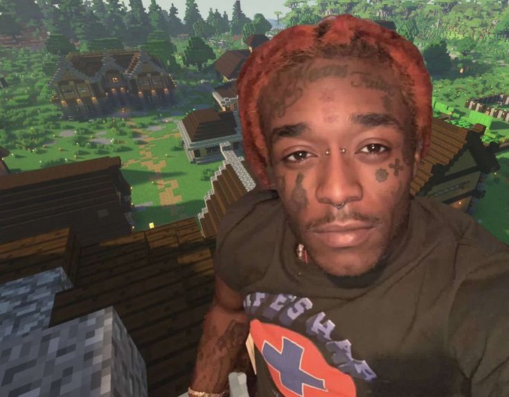 a man with tattoos on his face in front of a minecraft village and trees