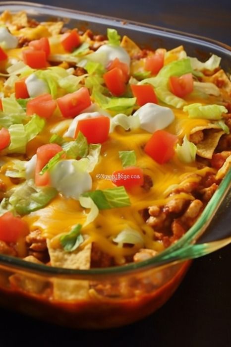 a casserole dish filled with meat, cheese and veggie toppings