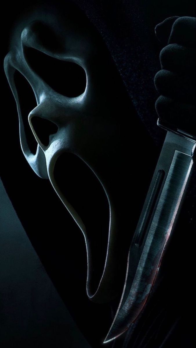 a person wearing a mask holding a knife