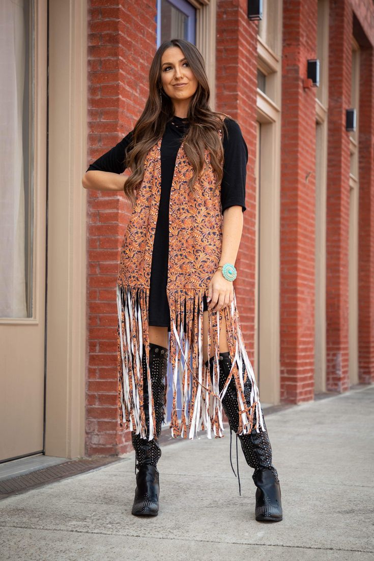 Western Tooled Fringe Vest Women's tooled print vest with fringe and studs. The perfect addition to your western style wardrobe. Model is wearing a size small 95% Polyester/5% Spandex Size Guide: Women's body measurements (inches) Sizes Small 6-8 Med 10-12 Large 14 XL-1X 16-18 2X 20-22 3X 24 Bust 35-36" 37-38.5" 40" 41.5-45" 47-49" 51" Waist 29.5-31" 32.5-34" 35" 37-39" 41.5-42" 44" Hips 36-36.5" 37.5-38" 40" 42-45" 45.5-46.5" 48" Sleeveless Vest For Fall Festival, Brown Fringe Vest For Festival, Festival Fringe Brown Vest, Brown Sleeveless Fringe Vest, Fall Festival Vest With Fringe, Brown Fringe Vest For Fall, Fall Sleeveless Vest With Tassels, Fitted Fringe Vest For Festivals, Fitted Fringe Vest For Festival