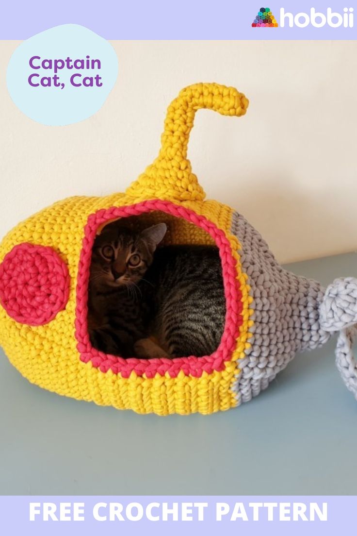 a cat is sitting in a crocheted fish shaped bed with the caption captain cat, cat