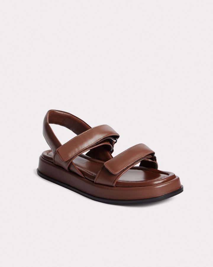 Marrying the ease of everyday wear with luxurious materials, The Sporty Sandal draws inspiration from hiking-inspired influences and timeless design. Made in Italy, the buttery soft leather straps are designed to securely fasten with Velcro® for an adjustable fit. Cushioned and chunky, this double strap sandal epitomises on-the-go luxury with a look that’s as practical as it is stylish. Double Strap Sandals, Sporty Sandal, Black Strappy Sandals, Everyday Luxury, Fit Details, Comfortable Heels, How To Make Shoes, Recycled Leather, Everyday Luxuries