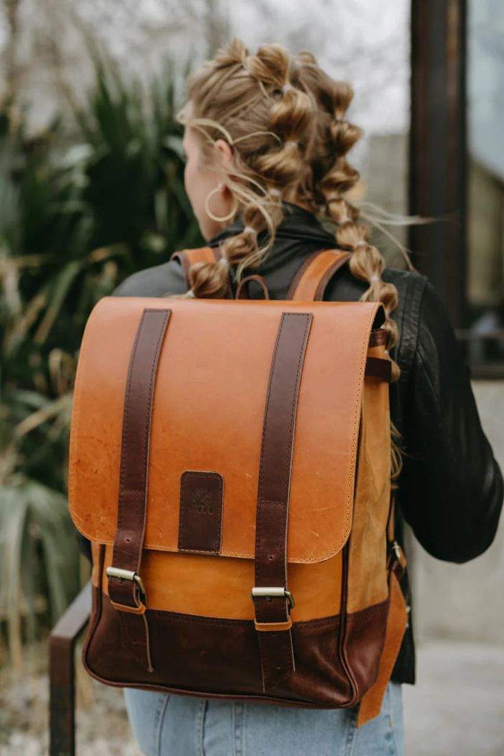 This Leather Backpack is the perfect way to travel for your meetings, work trips or everyday errands!Dimensions:14" W x 17" HFeatures:• Fits 13" laptop• Interior slots and zipper pocket• Exterior zipper pocket on back• Natural brass closures• Adjustable Leather straps Standard Backpack With Laptop Sleeve For On-the-go, Laptop Bag With Sleeve For Daily Use, Standard Backpack, Laptop Backpack With Laptop Sleeve For Daily Use, Travel Laptop Bag With Sleeve In Standard Backpack Shape, Travel Laptop Bag With Sleeve, Travel Laptop Bag With Laptop Sleeve, Classic Travel Backpack With Laptop Sleeve, Daily Use Laptop Backpack With Luggage Sleeve, Daily Use Laptop Bag With Laptop Sleeve