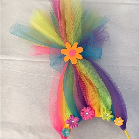 a rainbow colored headband with flowers on it