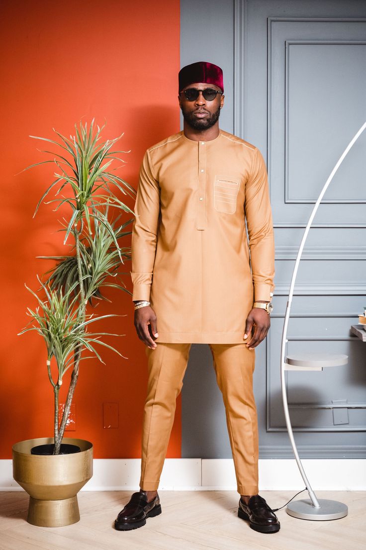 Traditional Trims - Premium Tan Long Sleeve Set Size: Please order the Kaftan according to our Traditional Trims sizing guide or bespoke measurements. Material: Kaftans are crafted from high-quality premium wool. Color Selection: Explore our range of available colors, providing you with a diverse color selection to choose from to suit your preferences and style. Functionality: This Kaftan set is versatile, making it ideal for various events or celebrations such as weddings, business meetings, da Kaftan Set, African Elegance, Knee Pants, Dress Pant, Long Tops, Suits You, Bespoke, Casual Shirts, Dresses With Sleeves