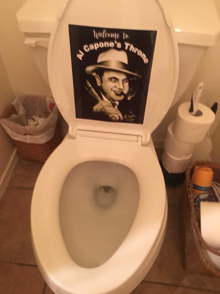 there is a toilet with a poster on the lid