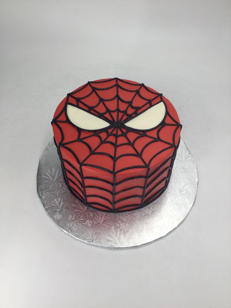 a spiderman cake on a silver platter