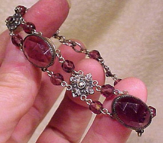 An Edwardian Czech purple faceted glass silver plated bracelet circa 1910 1920. This vintage 7" length bracelet has amethyst-purple glass faceted, to look like gems. It has oval and round stones and ornate silver plated flower seggments in between. It is not marked, but Czechoslovakia was not a separate country from the Austro-Hungarian empire until 1919. It closes with a (replaced) spring-ring clasp, and it is in otherwise excellent vintage condition with no chips, cracks, scrapes, dents, monog Antique Bracelets, Silver Plated Bracelet, Dope Jewelry, Purple Crystal, Funky Jewelry, Jewelry Lookbook, Purple Glass, Girly Jewelry, Faceted Glass