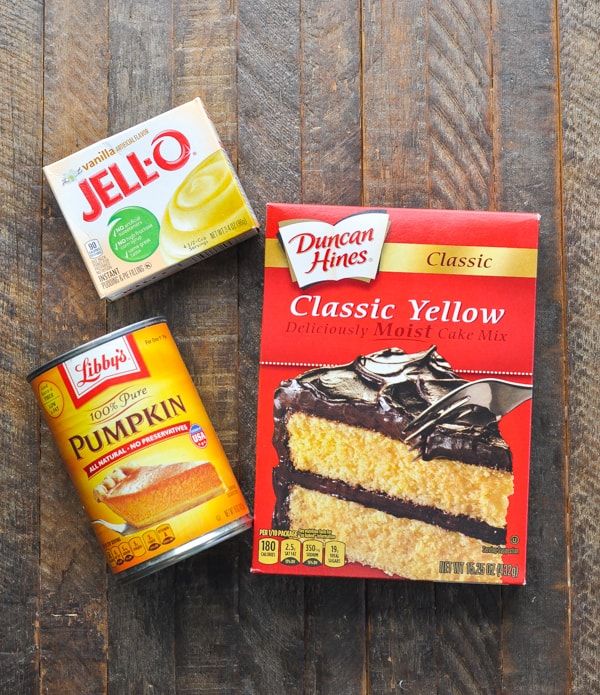 two boxes of jello and a can of cake mix on a wooden table top