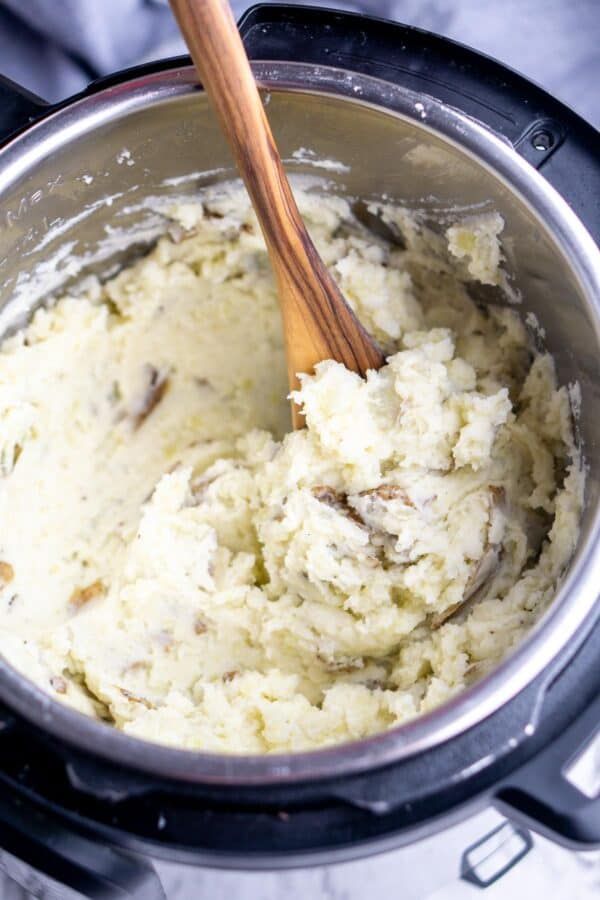 mashed potatoes in an instant pot with a wooden spoon