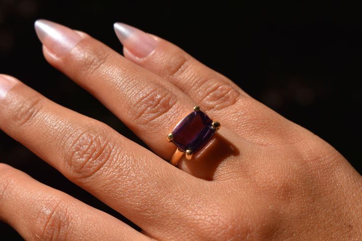 A natural Brazilian amethyst, handcrafted in Peru, set in an 18k solid gold band. Size: 6.5 Other size: 12 - 15 working days. Luxury Amethyst Ring Emerald Cut, Luxury Emerald Cut Amethyst Ring, Luxury Yellow Gold Amethyst Ring With Emerald Cut, Timeless Purple Rings Perfect For Gifts, Timeless Purple Rings As Gifts, Timeless Purple Rings For Gifts, Yellow Gold Amethyst Ring With Emerald Cut, Timeless Purple 14k Gold Rings, Timeless Tanzanite Rings As Gift