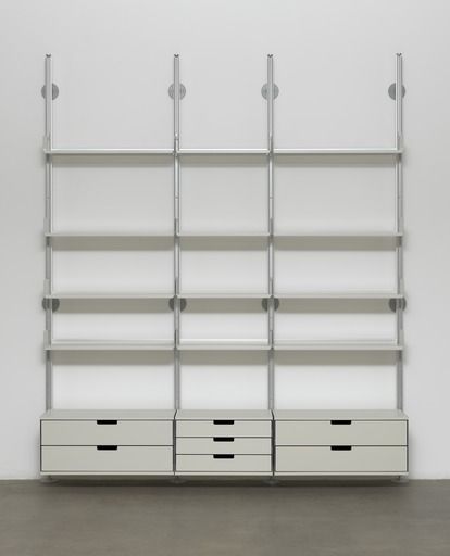 an empty bookcase with drawers in front of it and two white shelves behind it