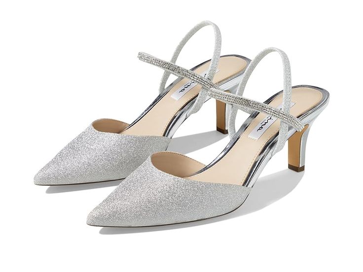 Nina Billie - Women's Shoes : Silver : Perfect for matching your evening gowns or wedding outfits, the Nina Billie pumps are designed with a front ankle strap with rhinestone detailing for a chic look. The synthetic midsole of these pump sandals offers you a comfortable walking experience. With their elastic back strap, these stylish pumps offer you durable support. Stylish and comfy, these heeled sandals are perfect to match your formal and party outfits. Glitter vinyl upper. Synthetic footbed Silver Wedding Heels, Shoes Silver, Silver Sandals, Wedding Heels, Silver Shoes, Party Outfits, Glitter Vinyl, Wedding Outfits, Pump Sandals