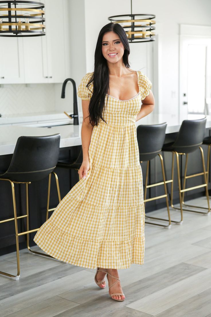 Laid back country style with a super sexy surprise in the back. Our Somewhere to Go Tie Back Gingham Print Dress has a classic gingham print, deep square neckline lined in lace and a ruffle-tiered skirt. The barely-there back connects by two ties, showing just enough skin for a classically, sultry look. Models are 5'3" and 5'4" wearing a size small Length of a small is 50" 50% Polyester, 50% Rayon, % Spandex, % Cotton, % Acrylic Plaid Square Neck Dress For Garden Party, Square Neck Plaid Dress For Garden Party, Gingham Square Neck Dress For Picnic, Spring Plaid Square Neck Dress For Brunch, Spring Picnic Plaid Dress With Square Neck, Spring Plaid Dress With Square Neck For Picnic, Fitted Plaid Dress With Square Neck For Picnic, Plaid Square Neck Dress For Brunch, Gingham Square Neck Dress For Day Out