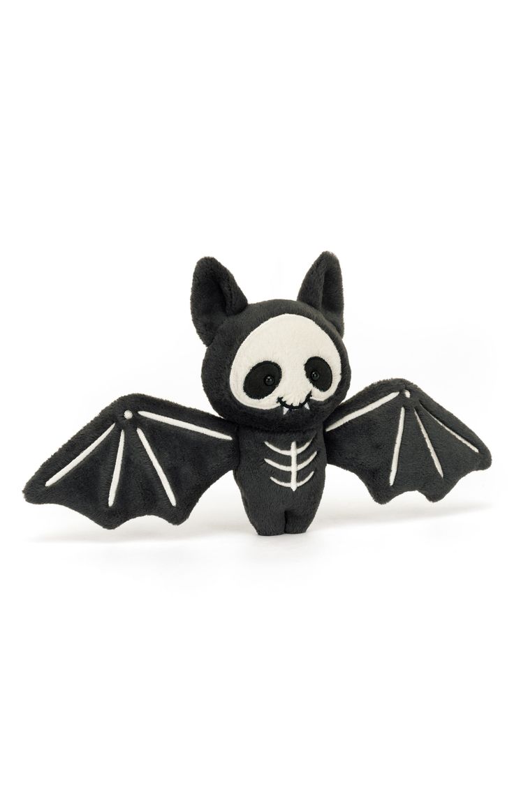 a black and white bat stuffed animal on a white background