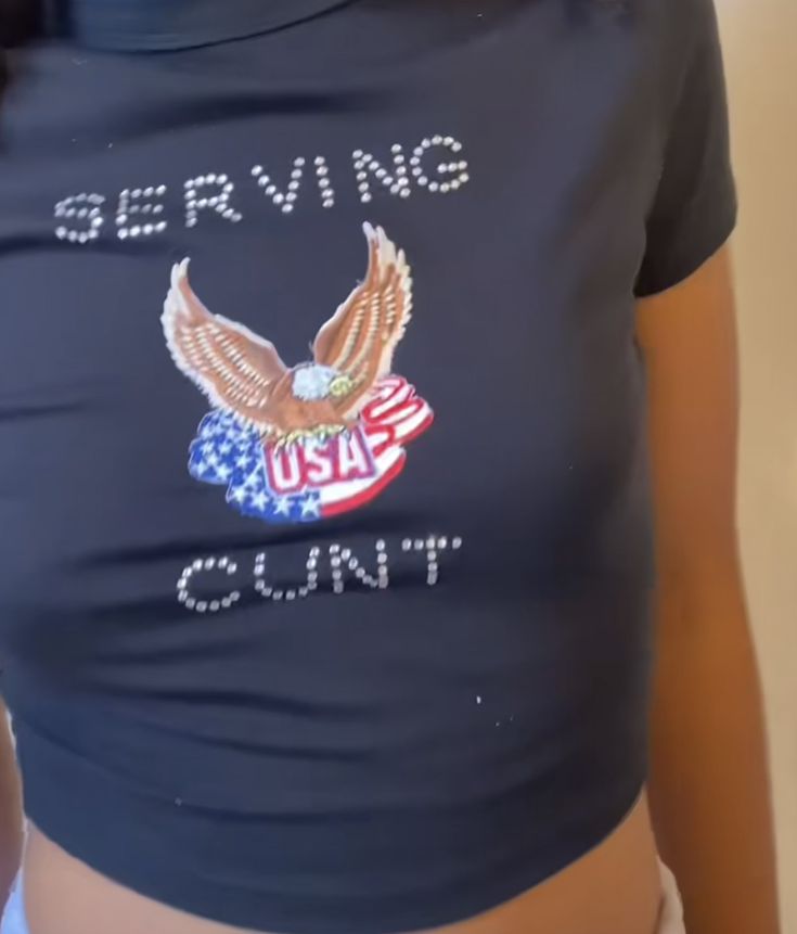 a woman wearing a t - shirt with an eagle and the words serving country on it