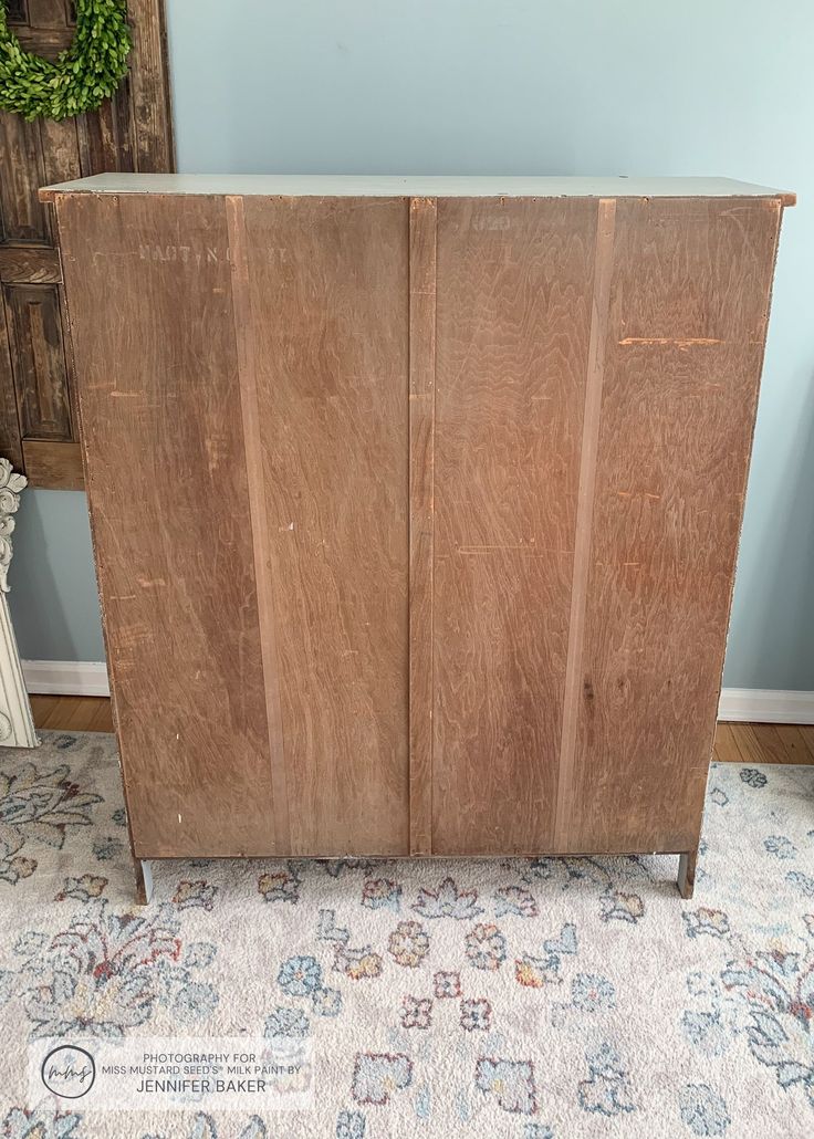 a wooden cabinet sitting on top of a rug