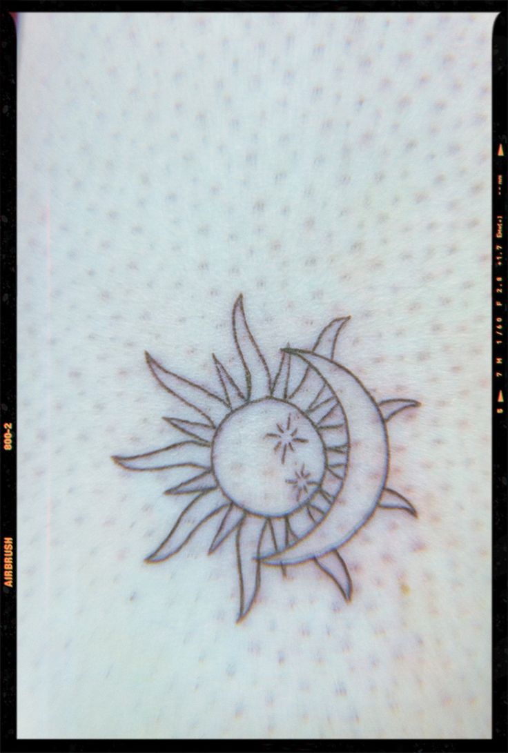 a drawing of a sun and moon on a white paper with black border around it