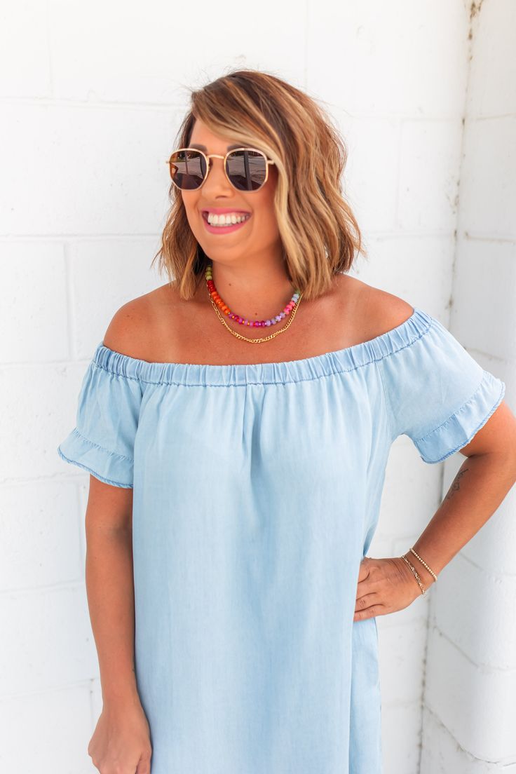 Get ready to slay the summer heat in The Right Time Chambray Dress! This frayed hem dress is perfect for hot days with its lightweight fabric, off the shoulder design, and relaxed fit. Plus, its versatile denim color makes it a must-have for transitioning into fall. Even expecting moms can rock this bump-friendly dress. Sizing: Ash is 5'4" 36C and is wearing a size Small Fit: Relaxed. If in between sizes, we recommend sizing down 1 size. Color: Light Denim Off the Shoulder Dress Raw Hem Ruffle D