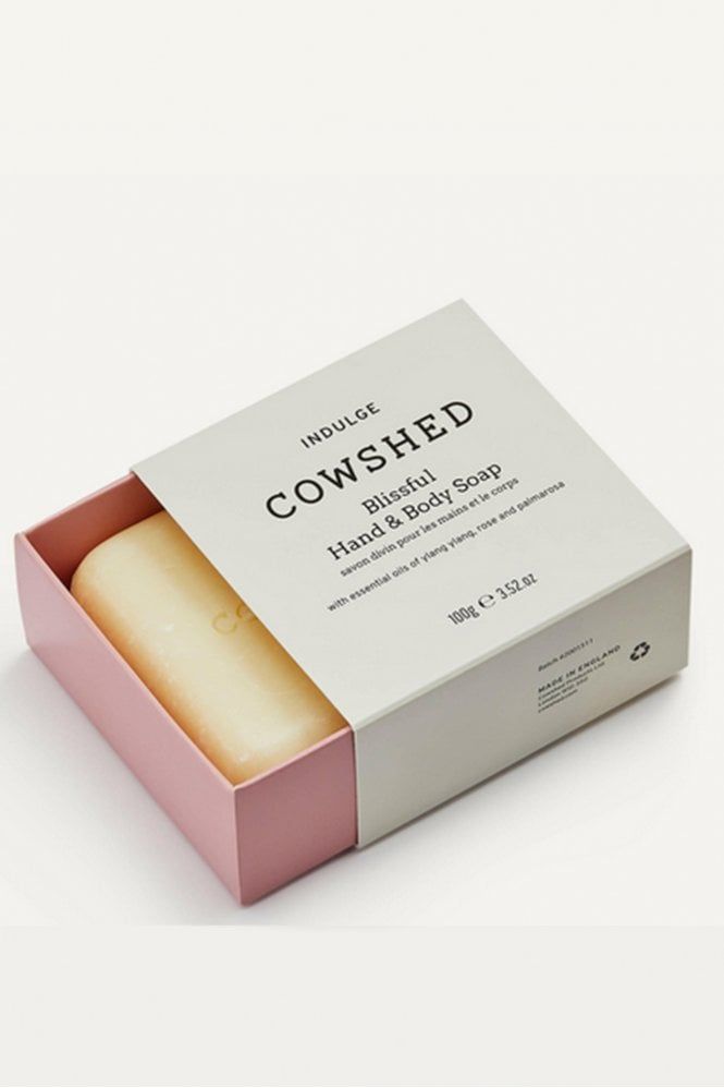 a pink and white box that has some kind of soap in it with the words cowshed on it