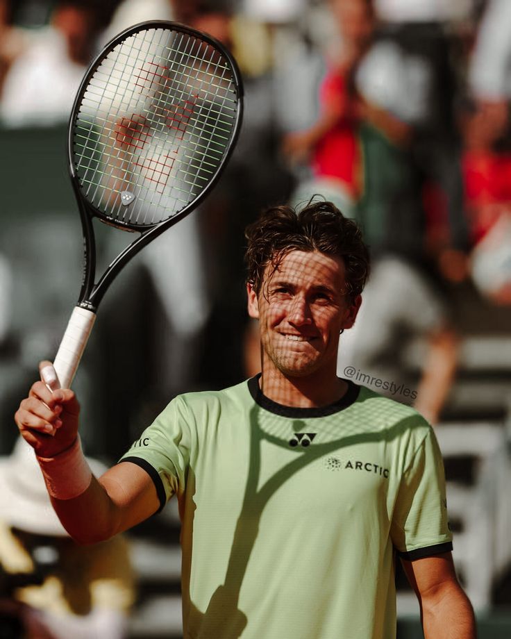 a man holding a tennis racquet in his hand