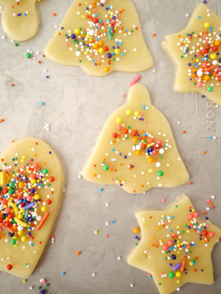 decorated cookies with sprinkles on a baking sheet