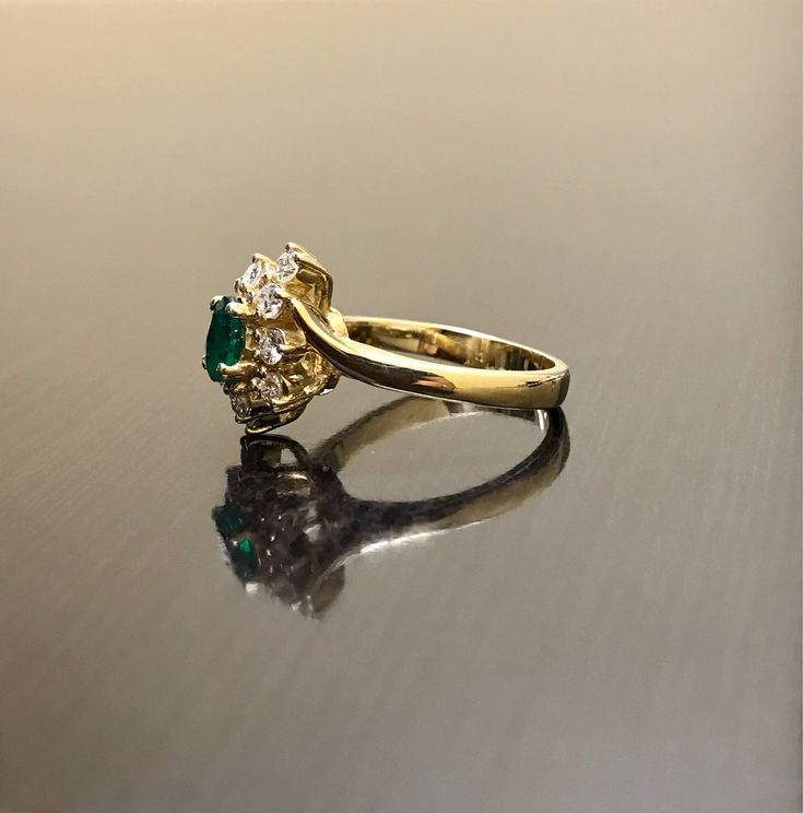 DeKara Designs Classic Handmade Art Deco Oval Emerald and Diamond Ring. This ring was entirely handmade by my father in the 1980's, anyone lucky enough to buy this ring will truly appreciate the workmanship and the beauty of this piece of art. Metal- 14K Yellow Gold, .583 Stones- 1 Oval Natural Green Emerald 0.45 Carats, 10 Round Diamonds, G-H color VS1 Clarity, 0.50 Carats. This ring is entirely put together piece by piece, and all the stones are carefully and expertly prong set. The ring is a Heirloom Emerald Ring With Halo Setting, Vintage Emerald Diamond Ring With Round Cut, Vintage Diamond Ring With Center Stone For May Birthstone, Antique Oval Emerald Ring For Anniversary, Vintage Emerald Ring With Brilliant Cut For May Birthstone, Vintage Emerald Ring With Brilliant Cut, Antique 14k Stamped Emerald Anniversary Ring, Antique Oval Emerald Anniversary Ring, Vintage Brilliant Cut Emerald Ring