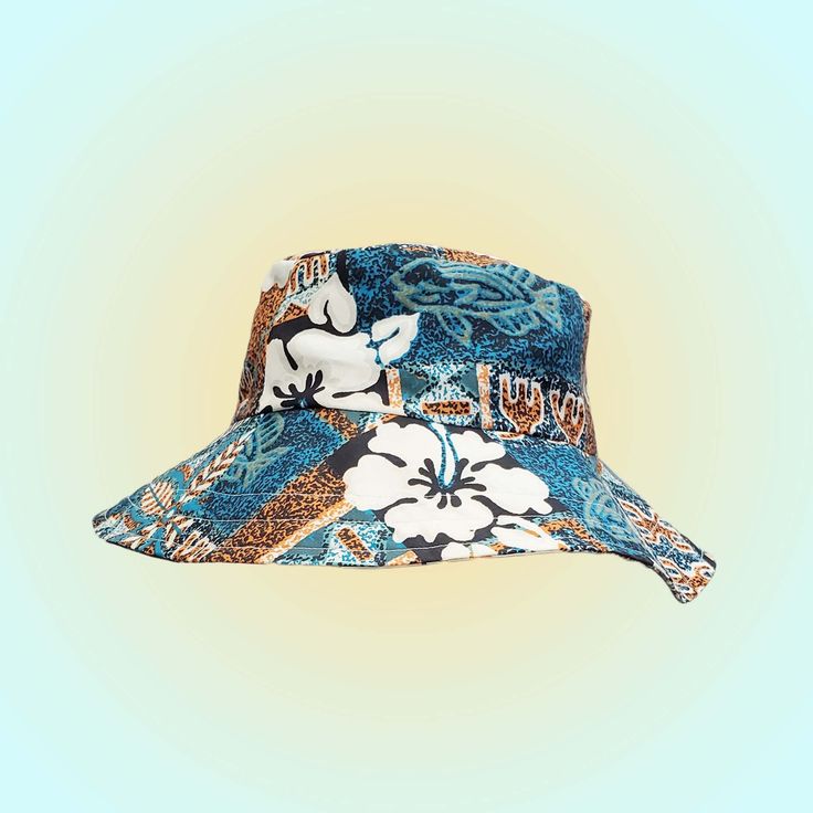 Stay stylish and comfortable while protecting yourself from the sun with this one-of-a-kind bucket hat. Our hat is hand-sewn from beautiful Polynesian fabric, which features intricate designs that are rich in history and culture.  Each hat is carefully crafted with attention to detail to ensure its durability and longevity. With its high-quality construction and stylish design, this hand-sewn bucket hat is the perfect addition to your wardrobe. Blue Summer Sun Hat For Festival, Blue Bucket Hat With Curved Brim For Festivals, Blue Curved Brim Bucket Hat For Festival, Blue Wide Brim Bucket Hat For Festivals, Blue Bucket Hat With Short Brim For Festivals, Blue Short Brim Bucket Hat For Festivals, Blue Summer Festival Hat, Blue Reversible Bucket Hat For Beach, Reversible Blue Bucket Hat For Beach