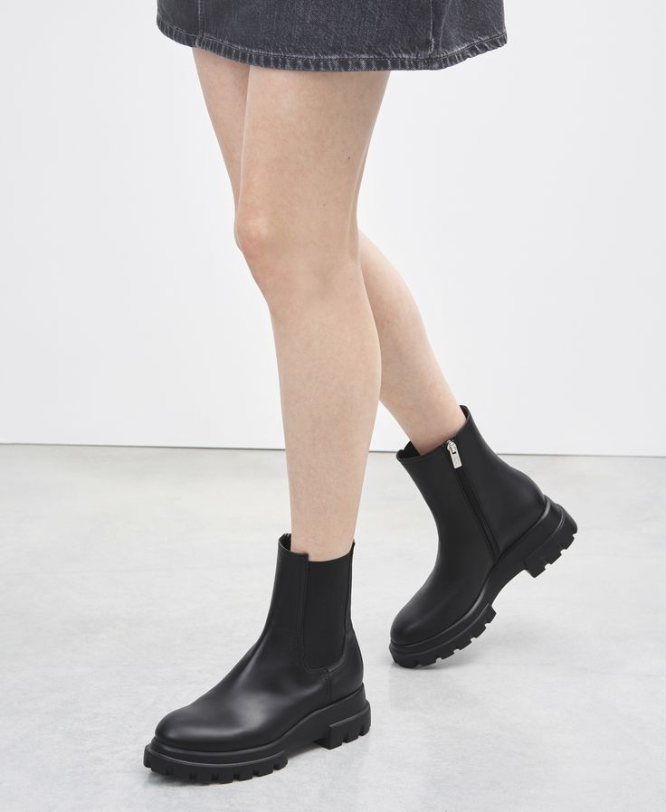 Leather ankle boot featuring a minimalist and avant-garde design. The simple upper is paired with a sole with graphic volume, made of lightweight rubber and adding height without compromising comfort. The elastic on one side and zipper on the other emphasize the practical style of this creation, which is easy to wear and perfect for dealing with the fast pace of the city. Practical Style, Moccasin Flats, Flat Booties, Low Boots, Boot Accessories, Boots And Sneakers, Sneaker Heels, Ballet Flat Shoes, Leather Ankle Boots