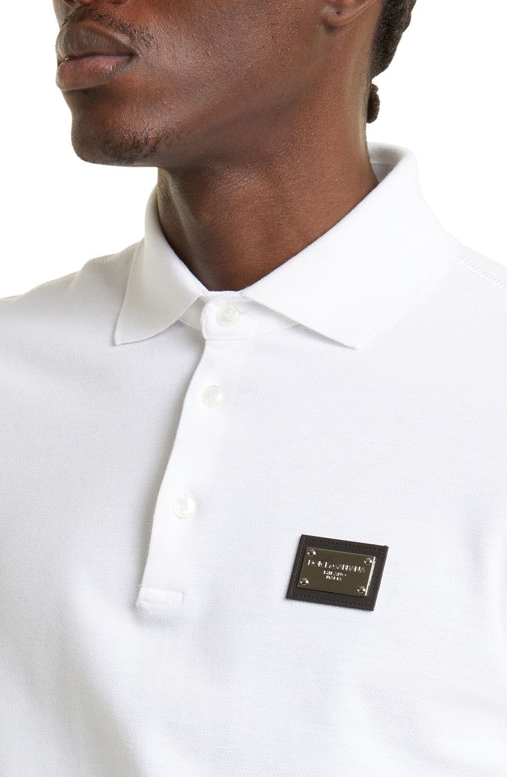 A shimmering logo plaque adds understated branding to this cotton piqué polo from the famed Italian duo. 25 1/2" length (size 46 EU) Button half-placket Spread collar Short sleeves 100% cotton Machine wash, tumble dry Made in Italy Men's Designer Clothing Classic Collared Polo Shirt With Logo Detail, Designer Polo Shirt With Embroidered Logo, Classic Polo Shirt With Logo Detail, Luxury Cotton Polo Shirt, Classic Polo Shirt With Embroidered Logo For Work, Elegant White Polo Shirt For Formal Occasions, Elegant White Formal Polo Shirt, Luxury Fitted White Polo Shirt, Designer Collared Polo Shirt For Formal Occasions