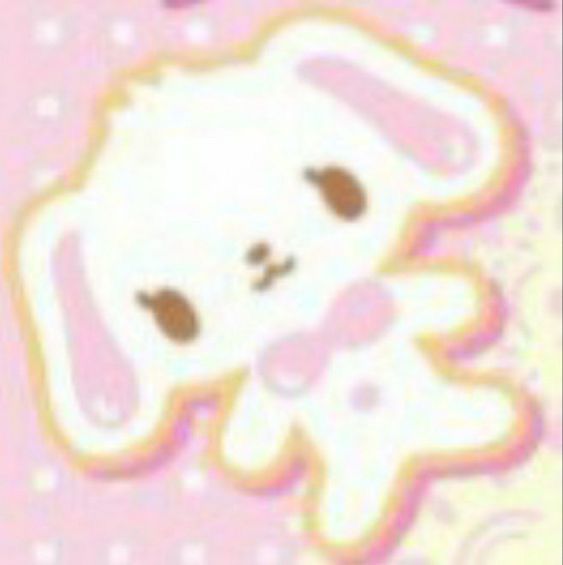 a white teddy bear sitting on top of a pink background