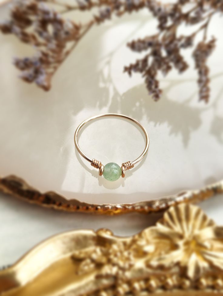 ✨ Dainty Light Green Jade Ring for Women ✨14K Gold Filled, Rose Gold Filled, Sterling Silver Wire Wrapped Tiny gemstone Ring💚 Simple stackable ring with a genuine green Jade, the good-luck stone. Jade is believed to bring protective, lucky-charm energy to the wearer 💚Sizing:• Gemstone Diameter: 4 mm• Ring Band: 0.8 mm • Handmade in your ring size with natural gemstone beads. • Dainty & cute. The ring is slim and petite, yet durable to wear daily. • Gold-filled is known for its lasting quality. 14k Gold Rings With Natural Stones For Gift, Dainty Jade Gemstone Jewelry, Green Dainty Crystal Ring With Birthstone, Green Stackable 14k Gold Jewelry, Stackable Green 14k Gold Jewelry, Green Birthstone Ring For Spiritual Occasions, Green Spiritual Birthstone Rings, Spiritual Green Birthstone Ring, Green Jewelry With Round Band For Gift