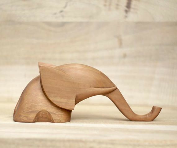 a wooden elephant figurine sitting on top of a table