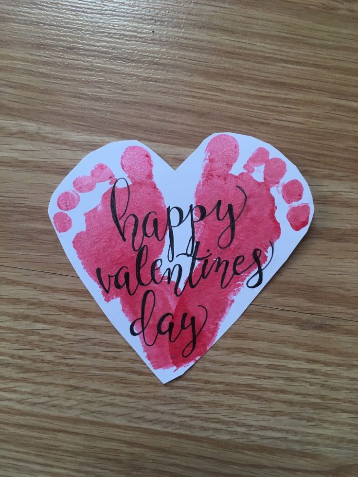 a valentine's day heart shaped card with handprinted hearts on it that says happy valentine's day