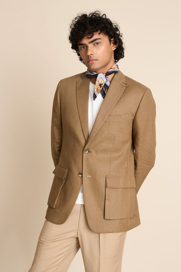 Khakhi blazer in a linen base with notch lapel collar, 2 cargo pockets, 1 barchetta pocket and loop detail at the collar.
Components: 1
Neckline: Notch Lapel
Sleeve Type: Long
Fabric: 100% Linen
Color: Beige
Other Details: 
Vented back
Sleeves with button closure
Unlined jacket
Closure: Button front
Note: The scarf, inner T-shirt and pant worn by the model is not for sale
Occasion: Cocktail and Reception - Aza Fashions Fitted Linen Blazer With Pockets, Notch Lapel Linen Blazer For Formal Occasions, Tailored Linen Blazer With Welt Pockets, Linen Blazer With Welt Pockets For Professional Wear, Business Linen Outerwear With Pockets, Classic Linen Blazer With Pockets, Business Casual Linen Blazer With Patch Pockets, Linen Blazer With Patch Pockets For Business Casual, Formal Linen Outerwear With Pockets