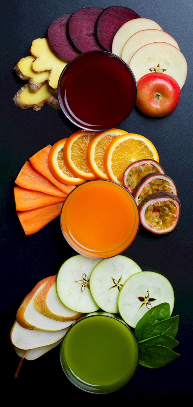 there are many different types of fruits and juices on the table with each one sliced in half