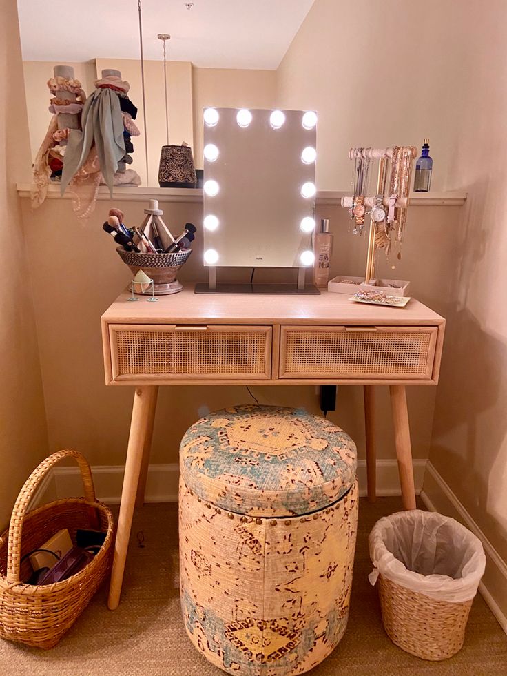 a vanity table with a mirror, stool and lights on it in the corner of a room