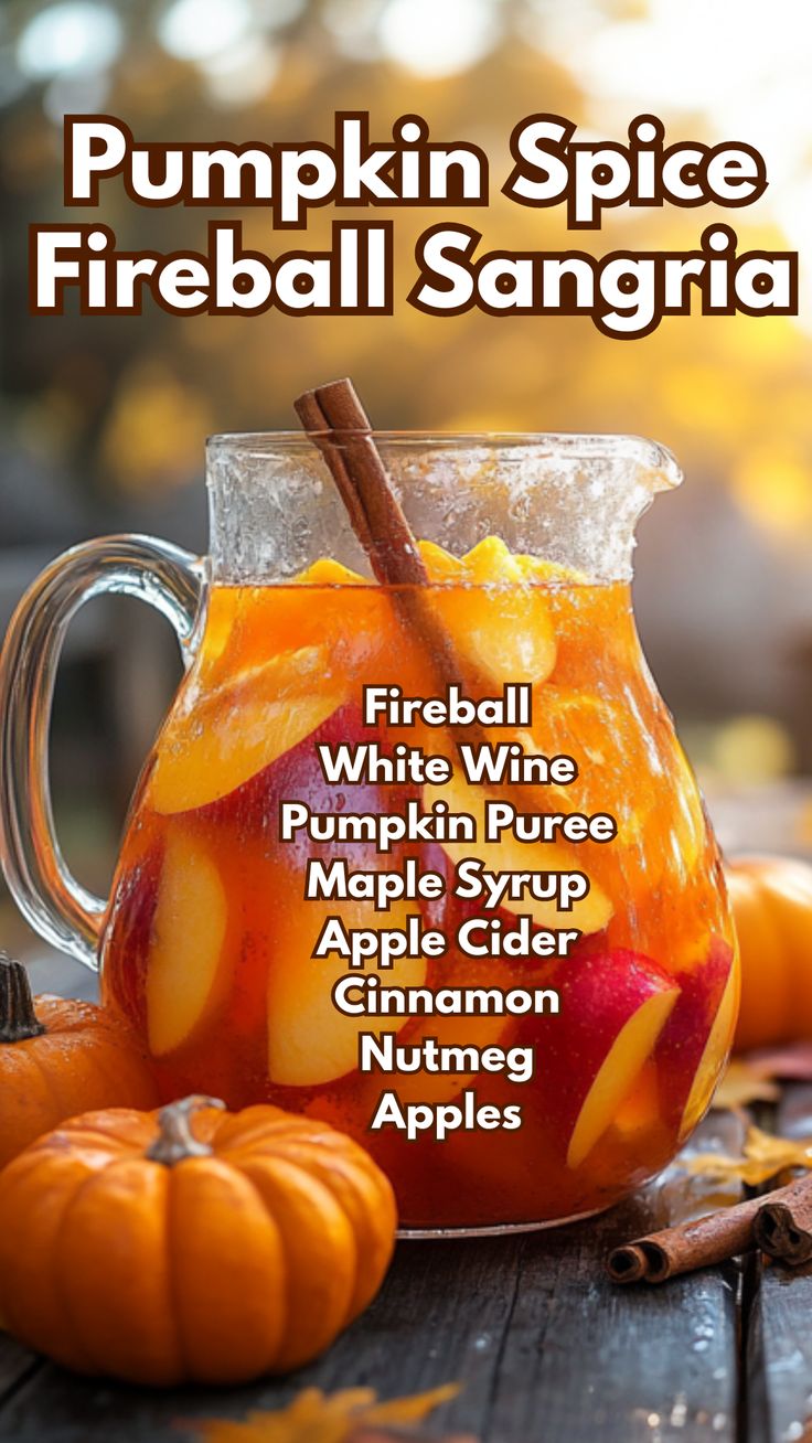 pumpkin spice fireball sangria in a glass pitcher with cinnamon and apples on the side