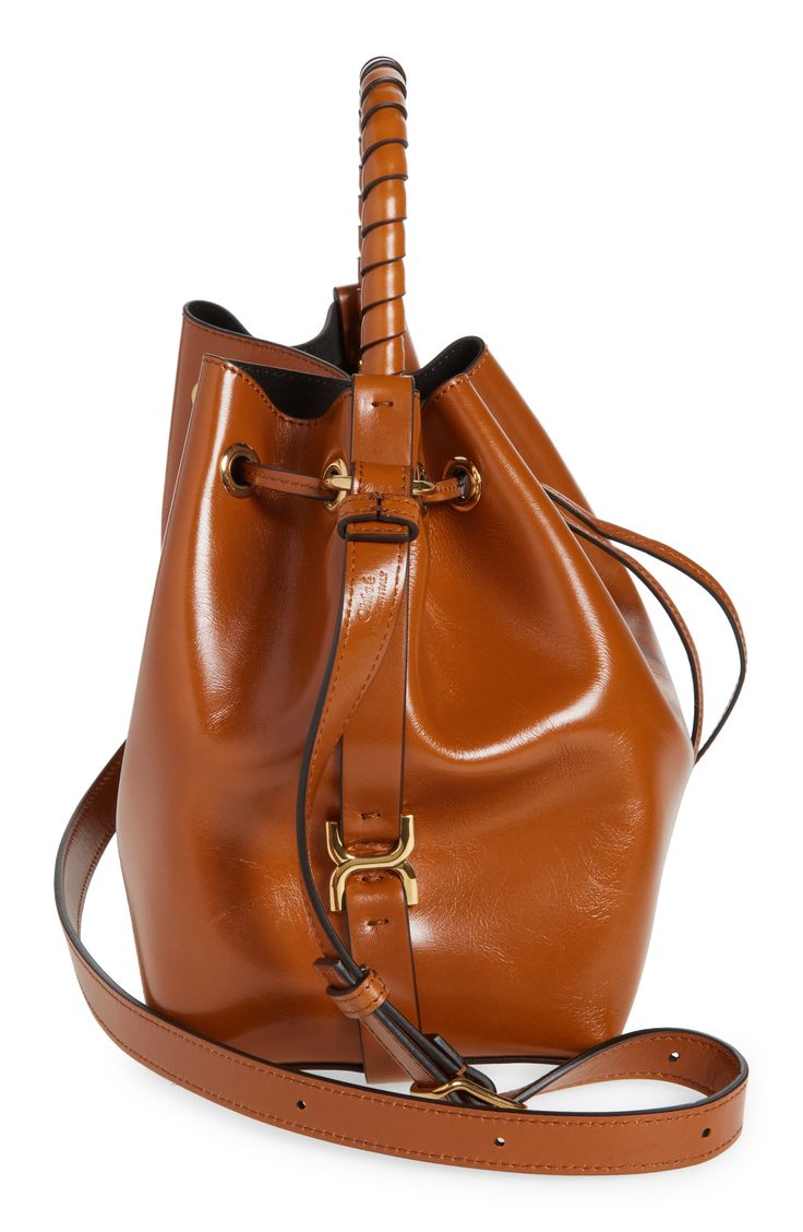 Signature whipstitching and stirrup-inspired hardware reflect the label's equestrian appeal on this roomy bucket bag made of richly polished calfskin leather. Drawstring closure Top carry handle; adjustable crossbody strap Structured silhouette with flat base for stability Leather Made in Italy Designer Handbags This brand has B Corp certification, representing business practices with emphasis on social and environmental performance, accountability and transparency This brand meets Nordstrom Res Brown Bucket Bag With Brass Hardware, Modern Leather Bucket Bag With Brass Hardware, Leather Satchel With Horsebit Detail, Leather Satchel Bag With Horsebit Detail, Designer Bucket Bag With Leather Handles For Office, Everyday Leather Bag With Horsebit Detail, Formal Leather Bucket Bag With Brass Hardware, Luxury Bucket Bag With Brass Hardware, Luxury Satchel Bucket Bag For Workwear