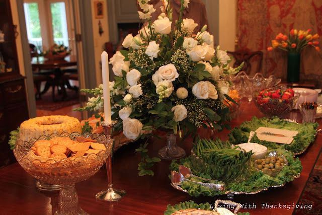 a dining room table filled with food and flowers on top of it's tables