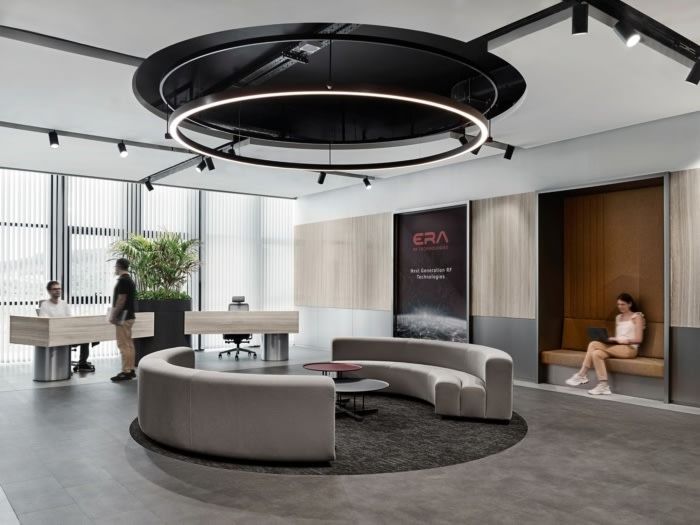 an office lobby with circular couches and tables