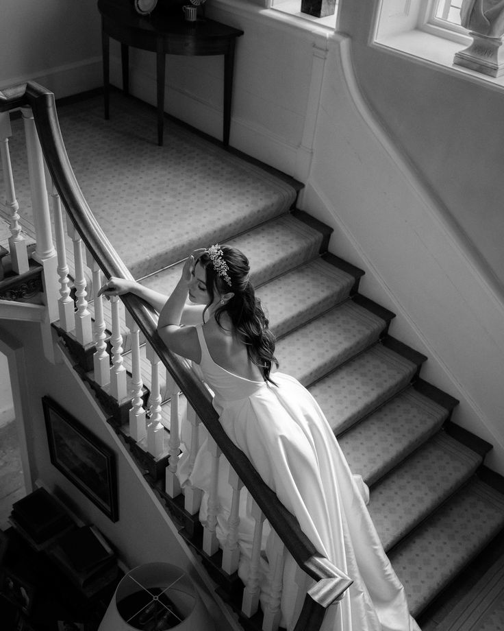 a woman in a dress is walking down the stairs